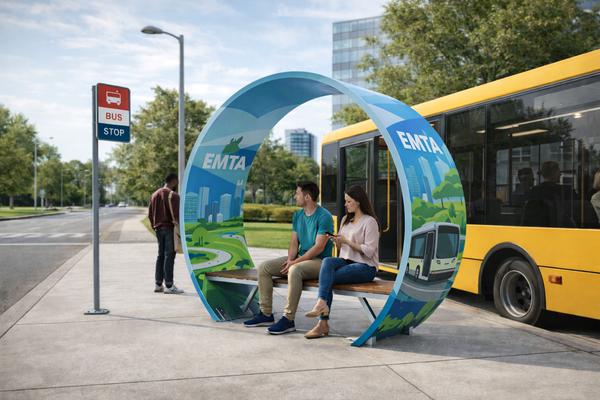 Sustainable Noblewins bus stop bench made from a recycled wind turbine blade with with art painted on it passengers waiting beside a public transit bus